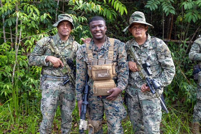 U.S. Marine Corps Cpl. Trequell Roberts, a rifleman with Fox Company, 2nd Battalion, 25th Marine Regiment and Mexican Marines pose for a picture at Jungle Amphibious Training School (JATS) during Tradewinds 23 at the Jungle Area Training Site, Guyana, July 16, 2023. Tradewinds is a U.S. Southern Command-sponsored exercise designed to strengthen partnerships and interoperability, promote human rights, as well as increase all participants' training capacity and capability to mitigate, plan for and respond to crises and security threats. (U.S. Marine Corps photo by. Cpl. Ryan Schmid)