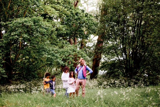 A group of children exploring the woods at Castle Howard, with a faerie-like creature called a Skelf