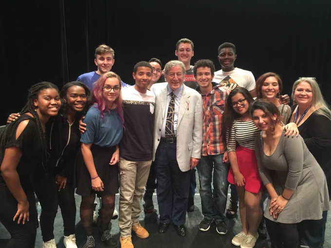 This photo shows Tony Bennett posing with a group of students in Astoria.