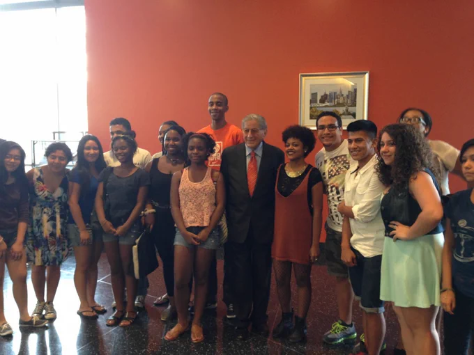This photo shows Tony Bennett posing with a group of students in Astoria.