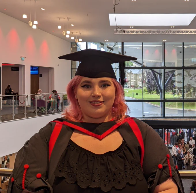 A person wearing graduation cap and gown