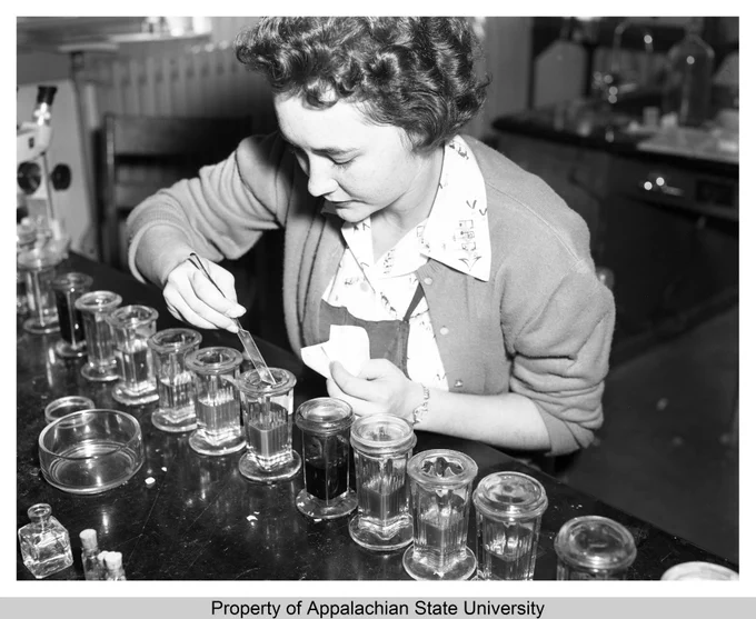 Description: This image shows student Carolyn Hutchins preparing a slide in the laboratory during the Biology 420 Microtechnique Course on November 10, 1958, in Smith-Wright Hall, built 1940, at Appalachian State Teachers College (1929-1967). Taught by Dr. L. Carpenter, the microtech lab was open twenty-four hours a day, during which students would work to produce 80 transparent, sectioned, stained, and labeled slides of plant or animal tissue to complete the course. The class had no other exams or written work. Students had to be science majors with two completed years of biology, a year of chemistry, and a year of physics, and be able to work independently.