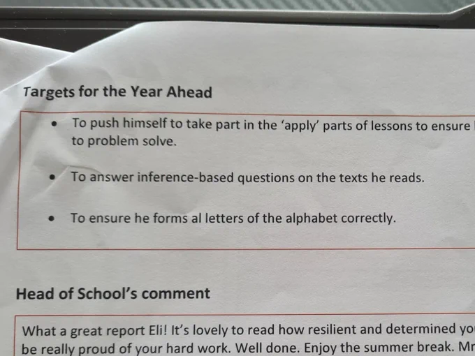 A school report with targets for the year ahead, Including 'To ensure he forms all letters of the alphabet correctly' (All has an L missing, ironic....)