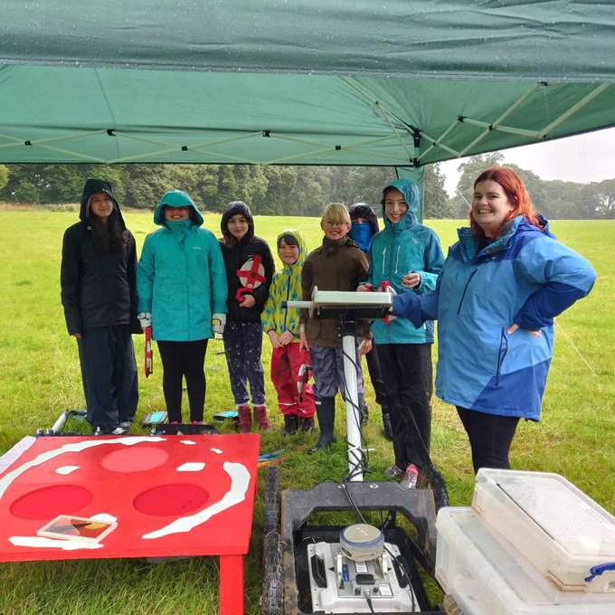 Children and adult with gpr kit under gazebo