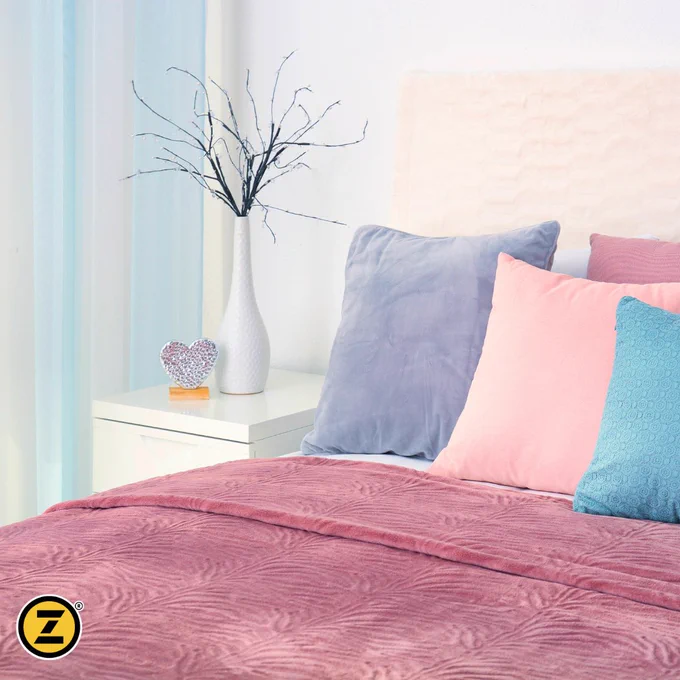 Beautifully cleaned comforter and pretty bedroom setting. 