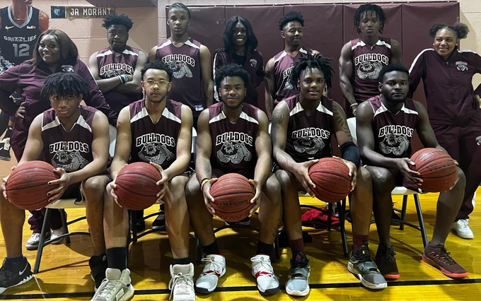 Gadsden Job Corps’ basketball team and cheerleaders pose for a photo in their uniforms. 