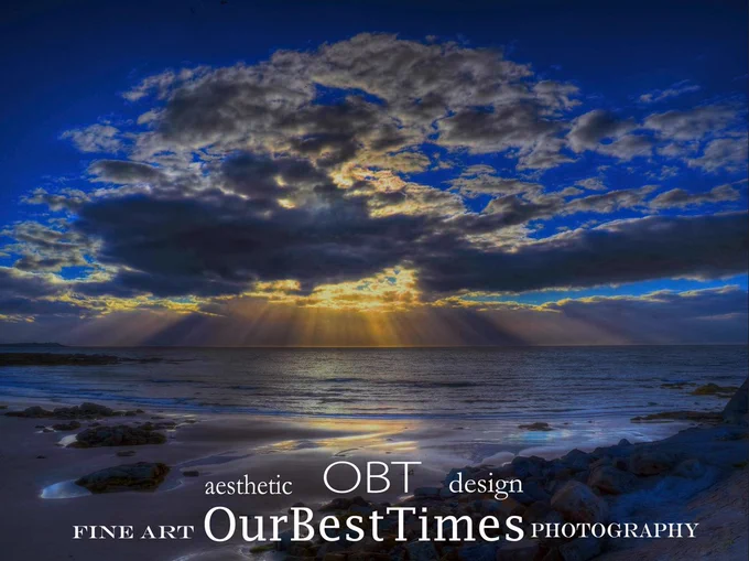 A sunset image over a beach focusing on the moments of indigo sky and last gold light...
