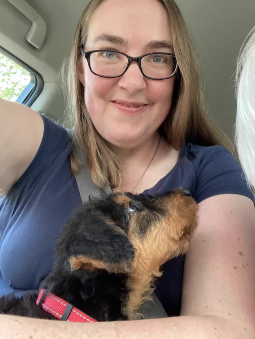 Me with a very small Airedale puppy in my lap