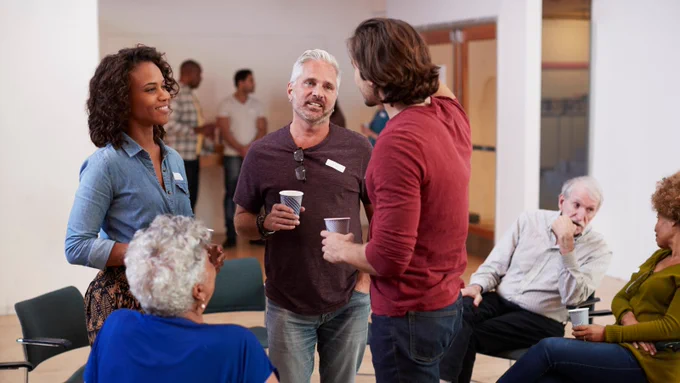 A group of people gather together in a community space
