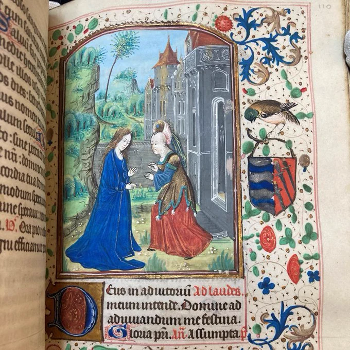 Image of the Visitation: Elizabeth and Blessed Virgin Mary stand near elaborate buildings in TCD MS 103 Book of Hours, f. 110. 