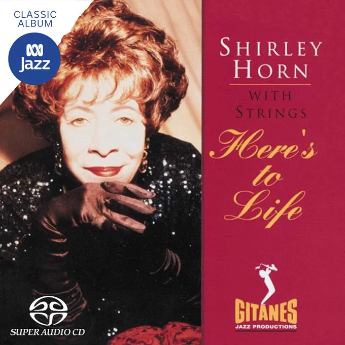 Shirley Horn poses in a black dress and velvet gloves, looking into the camera for her album cover of 'Here's To Life'.
