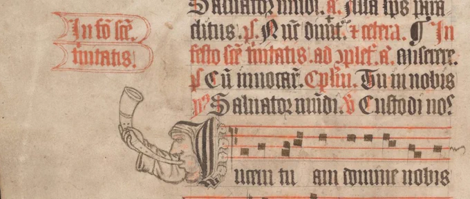 Image of a man blowing a horn surrounded by black and red letters and lines of musical staves in red, from TCD MS 77, f. 124v. 