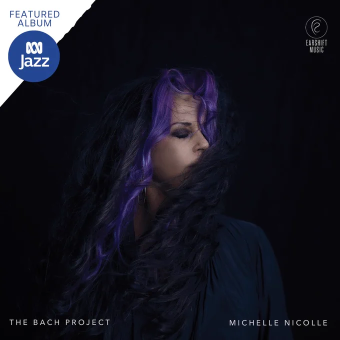 A shadowed photo of Michelle Nicolle with her eyes closed, looking to her left.