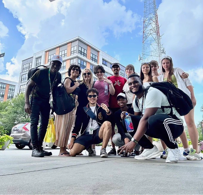 A group of students pose for the camera, smiling.