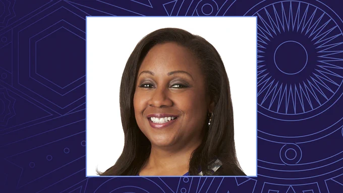 A headshot of Dr. Carlotta Arthur on a blue background.