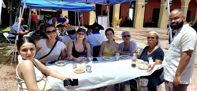 7 people enjoying a locally grown meal in #PuertoRico as part of Atma Connect's food events