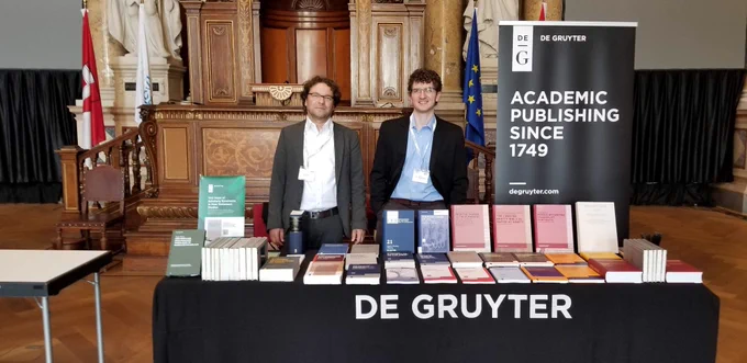 Albrecht Döhnert and Aaron Sanborn-Overby at the De Gruyter stand in Vienna.