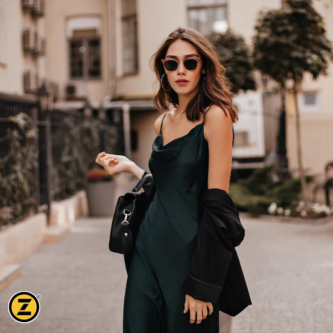 Woman on her way to a summer party, wearing a beautiful, freshly dry cleaned silk dress. 
