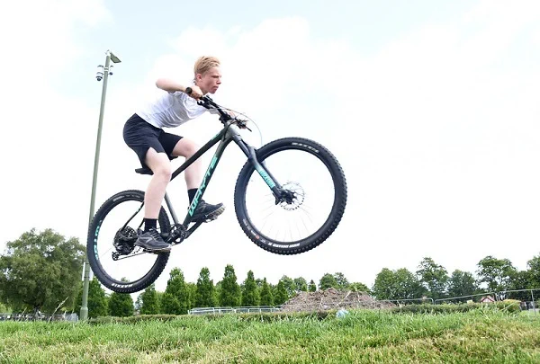 Young person getting some hang time on a mountain bike.