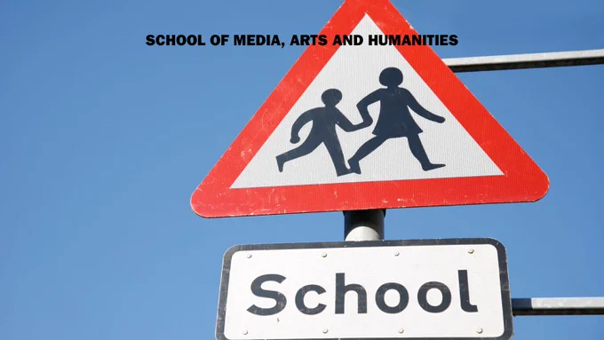 photograph of school road sign - hazard triangle with parent and child crossing road