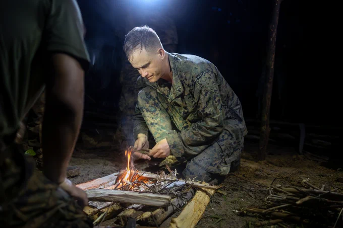 U.S. Marine Corps Capt. Ian Constable, company commander of Fox Company, 2nd Battalion, 25th Marine Regiment, 4th Marine Division, Marine Forces Reserve, starts a fire in Jungle Amphibious Training School during Tradewinds 2023 at Jungle Area Training Site, Guyana, July 22, 2023. (U.S. Marine Corps photo by. Cpl. Ryan Schmid)