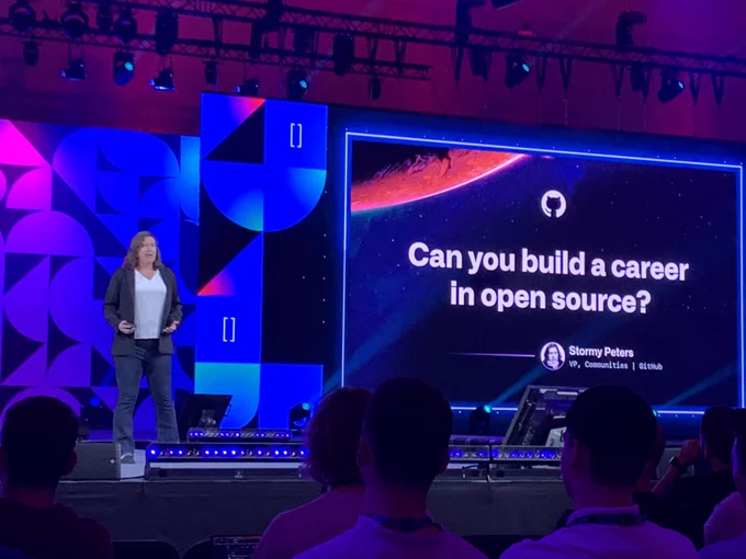 Stormy Peters on stage with presentation slide titled "Can you build a career in open source?"