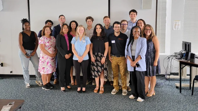 New York State Office of General Services Executive Team members pose for a photo with a group of student Interns on National Intern Day.