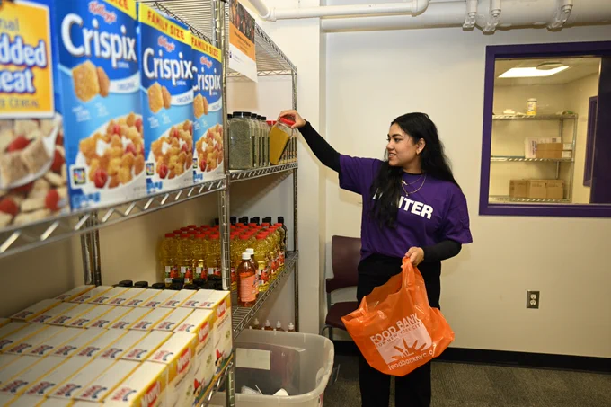 Hunter College student Hashina Sum browses spices in the food pantry.