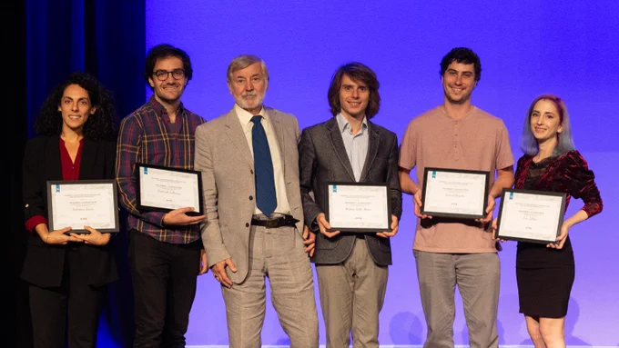 Valentina Bruno, Frederick Callaway, Samuel Cheyette, Erin Isbilen, and Mathias Sablé-Meyer stand together on stage, receiving an award from Robert J. Glushko.