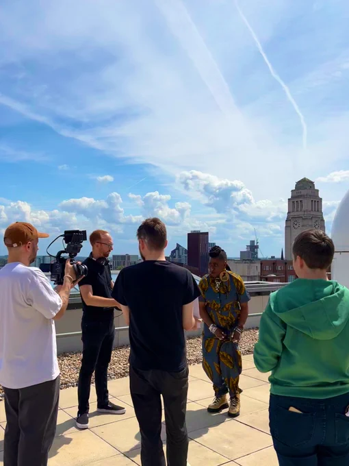 Film crew setting up a shoot with  Khadijah Ibrahiim on the rooftop of the Bragg building at University of Leeds with a view towards the Parkinson Building.