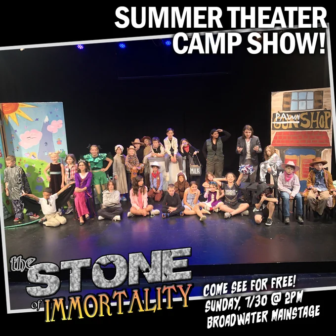The child cast of our summer camp show, "The Stone of Immortality," on the show's set. Some of the kids are dressed in old west clothing with a background that says "Gun Shop" with "Gun" crossed out and "Pawn" painted over it. On the other side of the stage is a backdrop of a sunny land with a green hill of flowers and a tall, pointed mountain in the distance with pink clouds. Other costumes for the kids include a queen, a wizard, a court jester, and a... bat boy? Come see and find out what's up with all this!