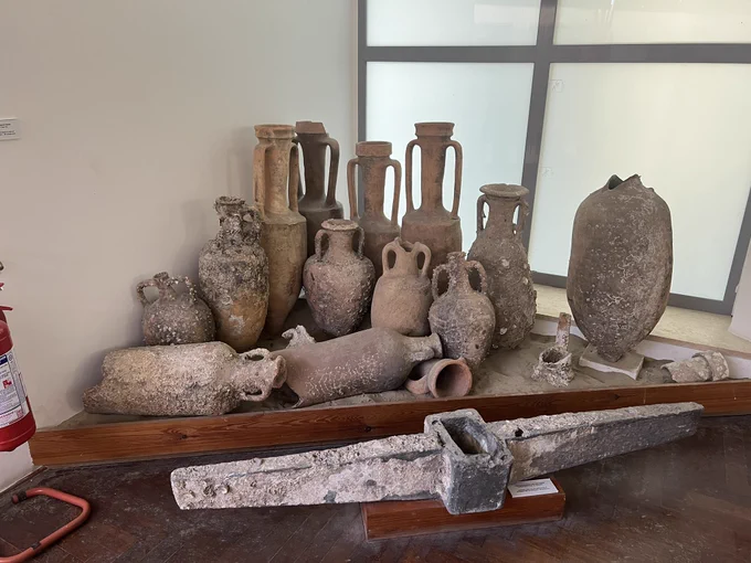 Collection of Amphorae and an anchor excellently positioned in a corner of the room