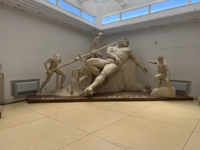 Polyphemus statue group. Odysseus and three others work to blind the giant cyclops who is lying on a rock.