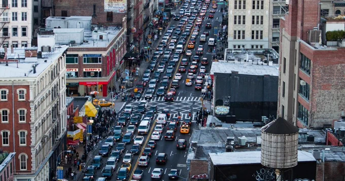 Congested city streets, pedestrian area confined to crowded space.