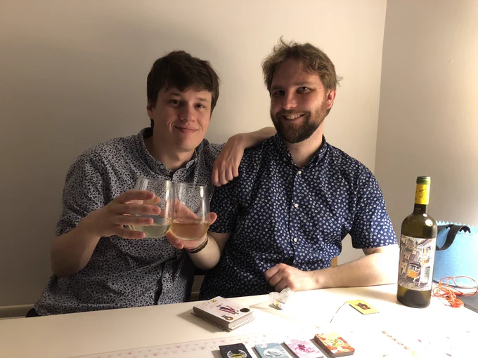 A photo of Mitch and Alastair enjoying a nice glass of wine, smiling together.