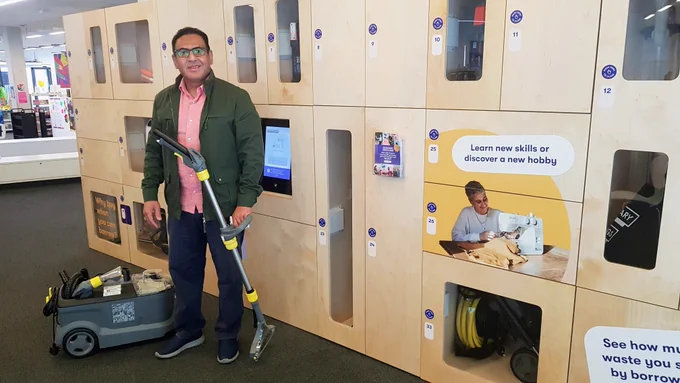 Our first borrower at Library of things holding a carpet cleaner