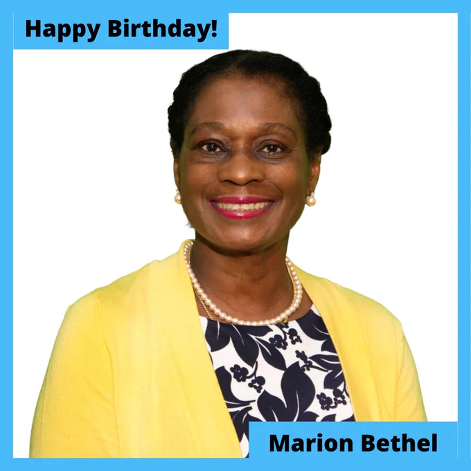 Image Description: A headshot of Marion, a Black woman with short hair, wearing a black and white floral print shirt with a bright yellow blazer and a pearl necklace. A light blue border around the photo says "Happy birthday Marion Bethel"