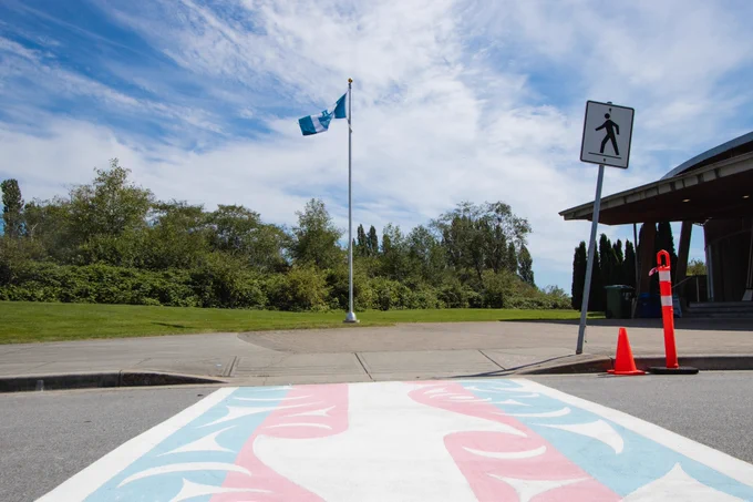 The Musqueam flag flying over the new crosswalk