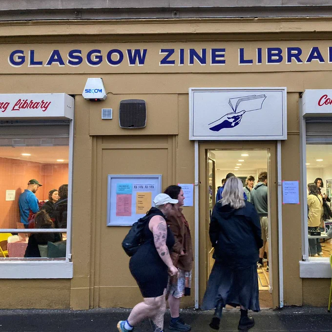 People entering the new zine library. You can see people inside through the windows.