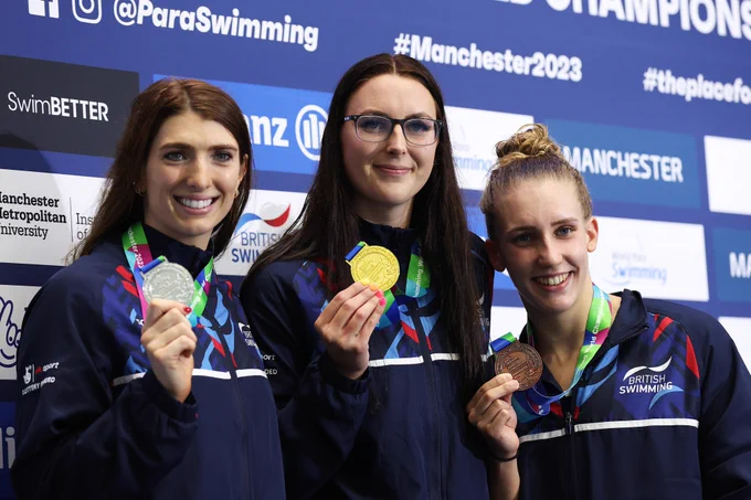 Bethany Firth (left), Jessica-Jane Applegate (centre) and Louise Fiddes (right) smile with their medals on the podium for the S14 Women's 200m Freestyle on day one of the Manchester 2023 Allianz Para Swimming World Championships.