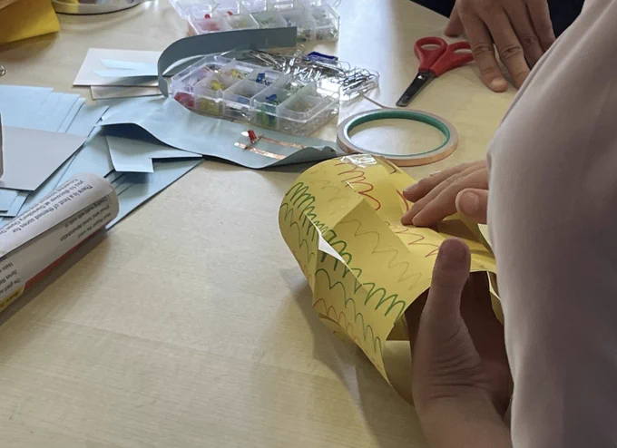 Close-up of a yellow paper lantern mid-construction.