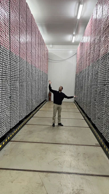 Person standing between six metre high racks of core samples at the Bremen Core Repository