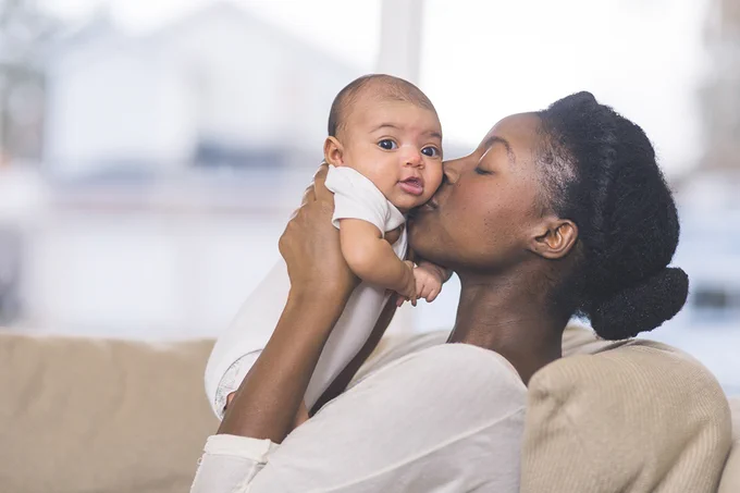 Woman holding a baby.