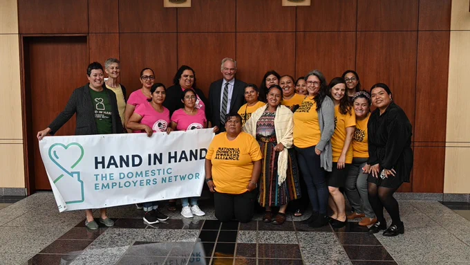Senator Kaine taking a photo with a group of people