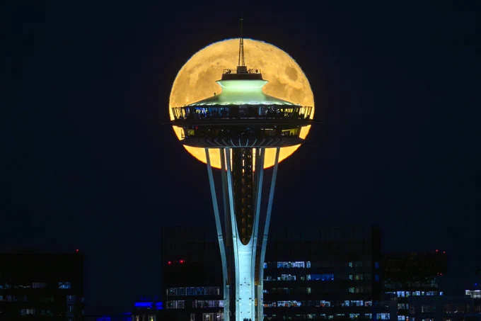 A full moon rising over the space needle in Seattle#
