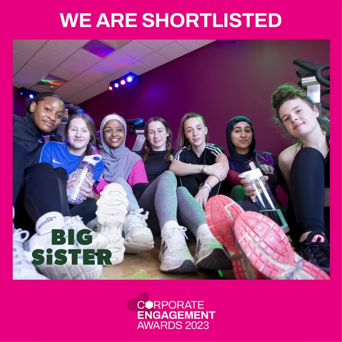 A group of 7 girls from different backgrounds sitting in their leisure centre