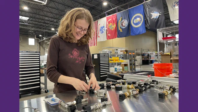 Image of Marley Albright working on a fluids system