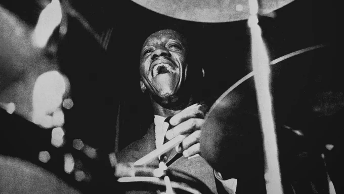 A monochrome shot of Art Blakey behind the drums in the 1950s