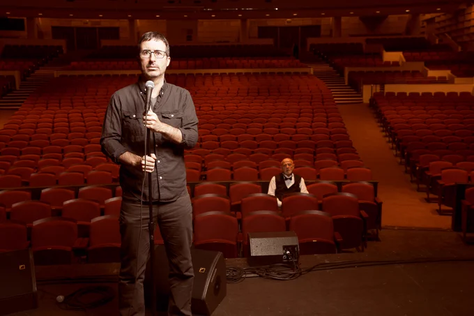 John Oliver will perform on September 17 at The Met Philadelphia, hopefully to more than one sad usher as pictured in this photo of an empty auditorium.