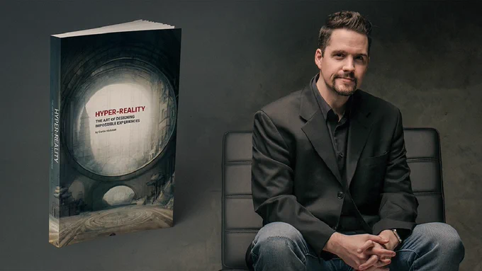 Picture of Curtis Hickman sitting in a chair next to his book titled Hyper-Reality: The Art of Designing Impossible Experiences.